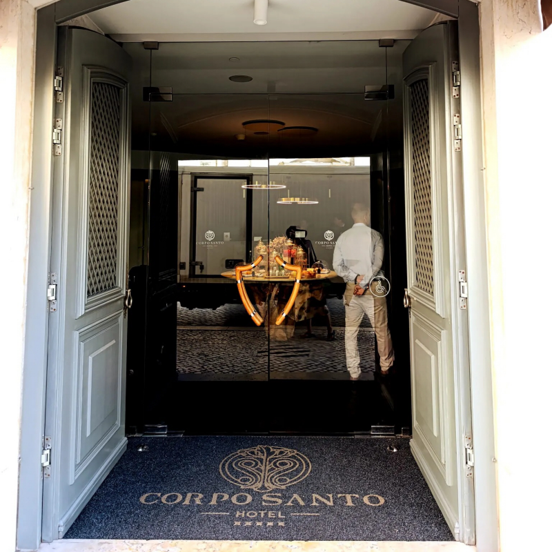Corpo Santo Hotel elegant entrance with mosaic logo and historic doors in Lisbon