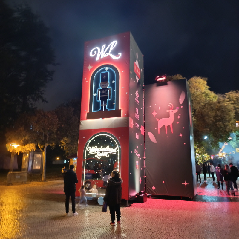 Tall, festive Christmas display at Wonderland Lisboa 2025 featuring a neon nutcracker soldier and a reindeer silhouette.